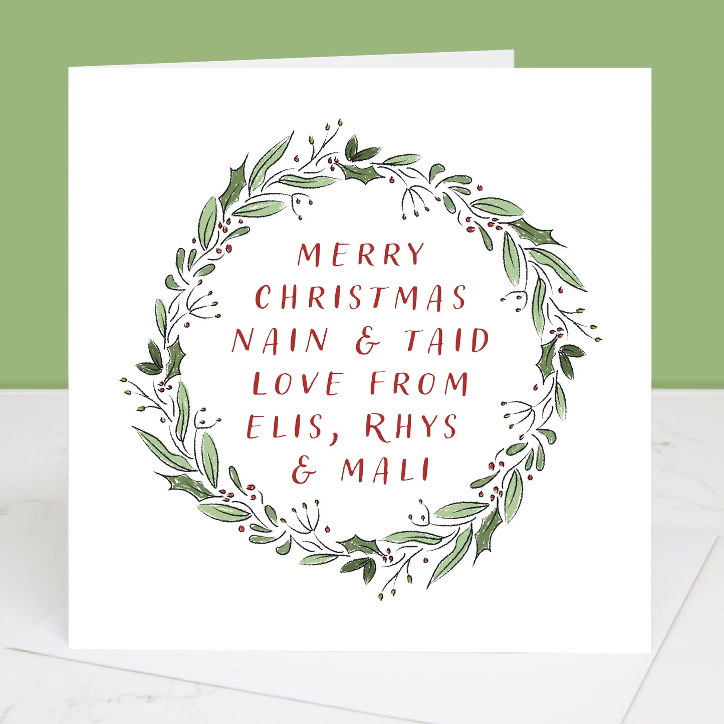 Personalised Grandparents Christmas card with green wreath and red text on a white background