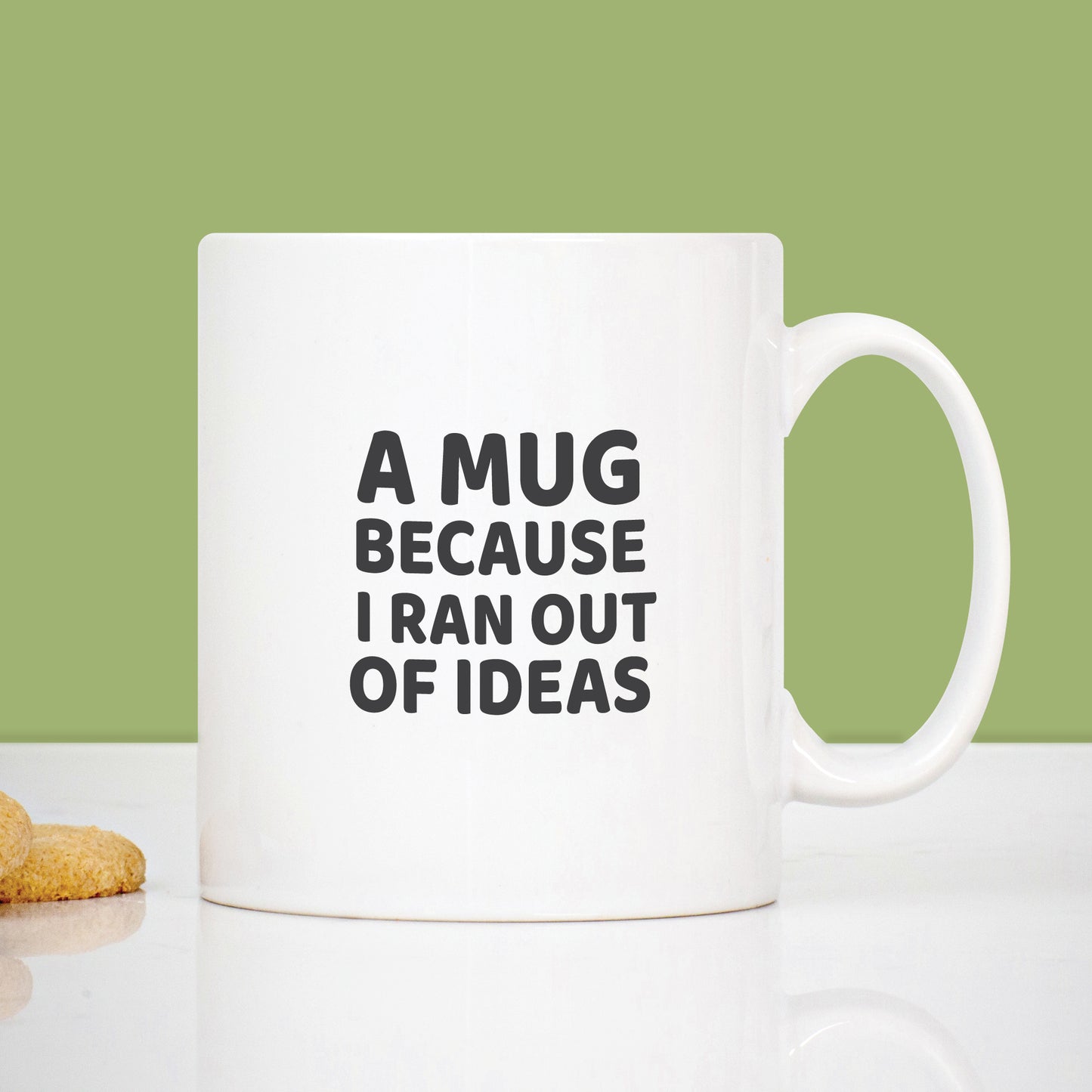 White mug with text 'A mug because I ran out of ideas' on a light green background