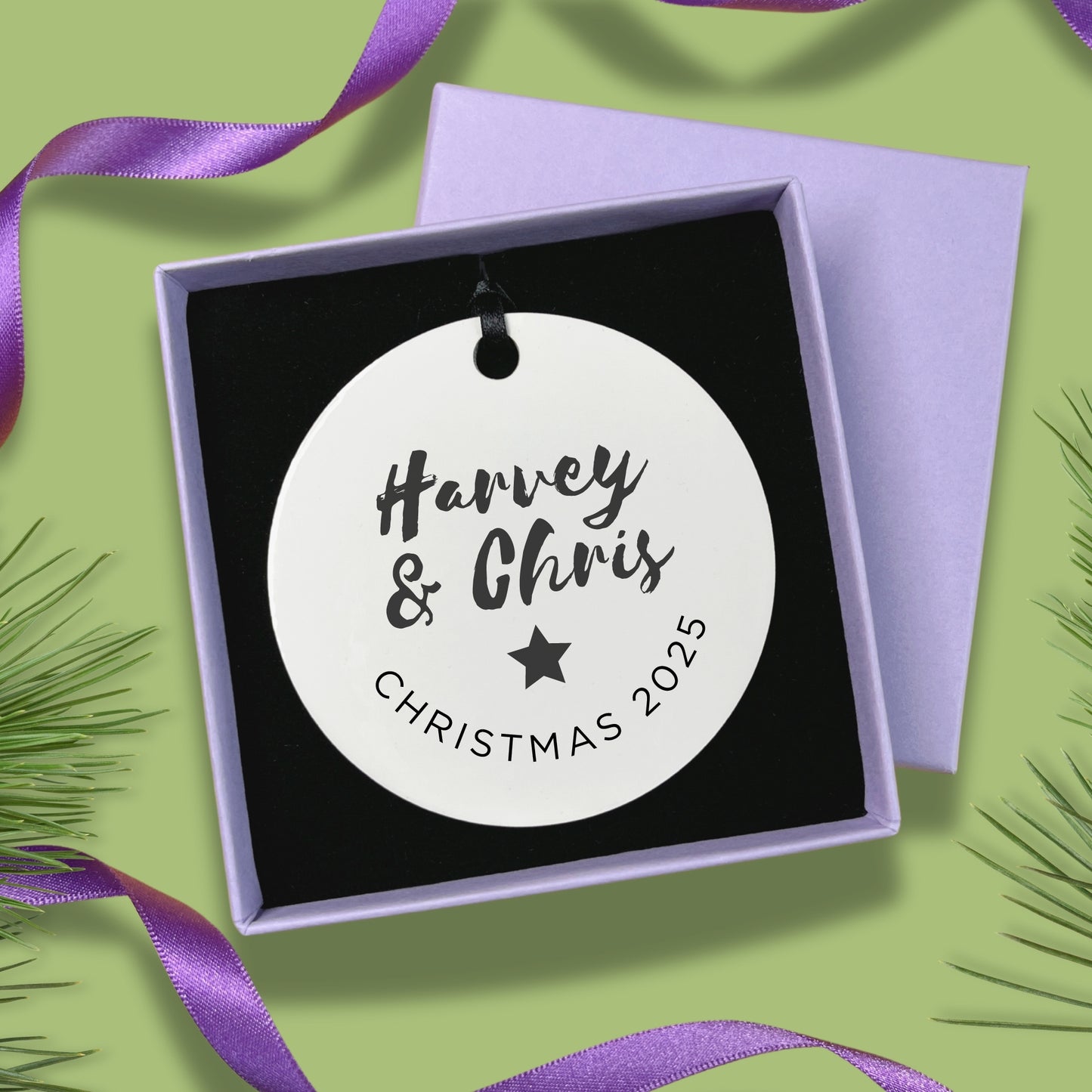 Round ornament with names in a purple box on a green background