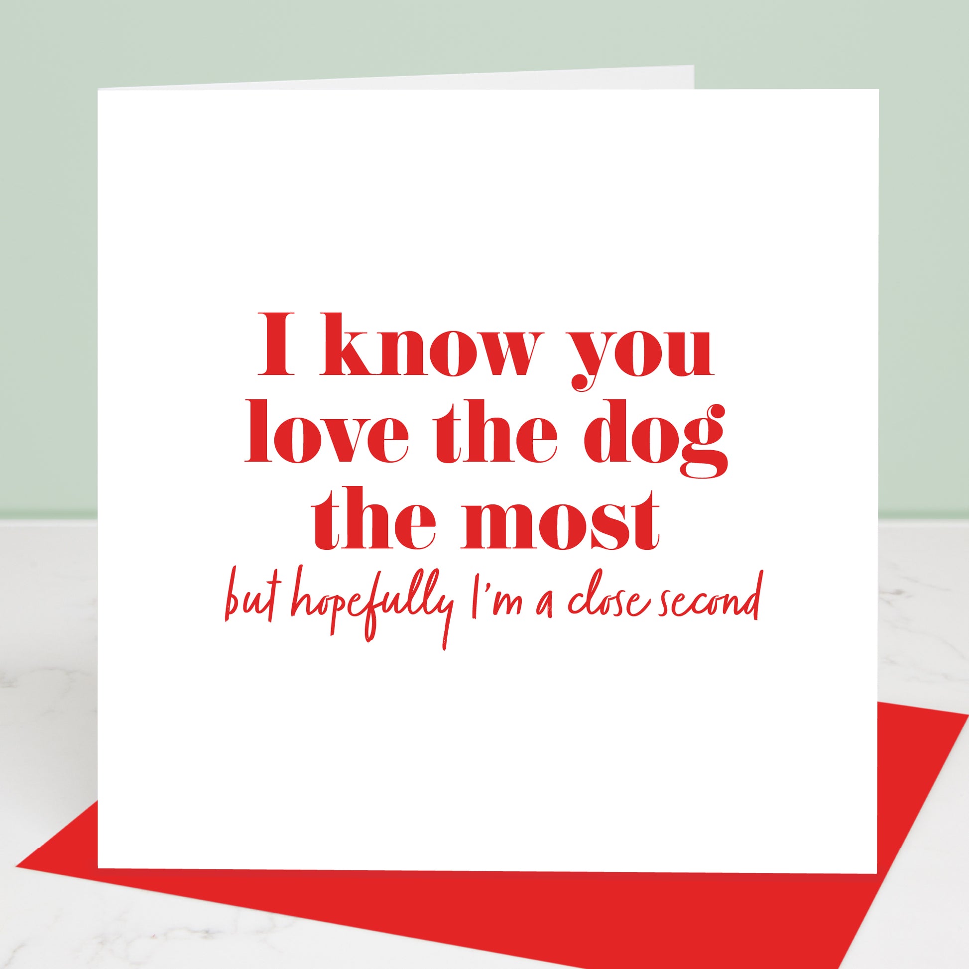 You love the dog the most valentine's card, red text on white background