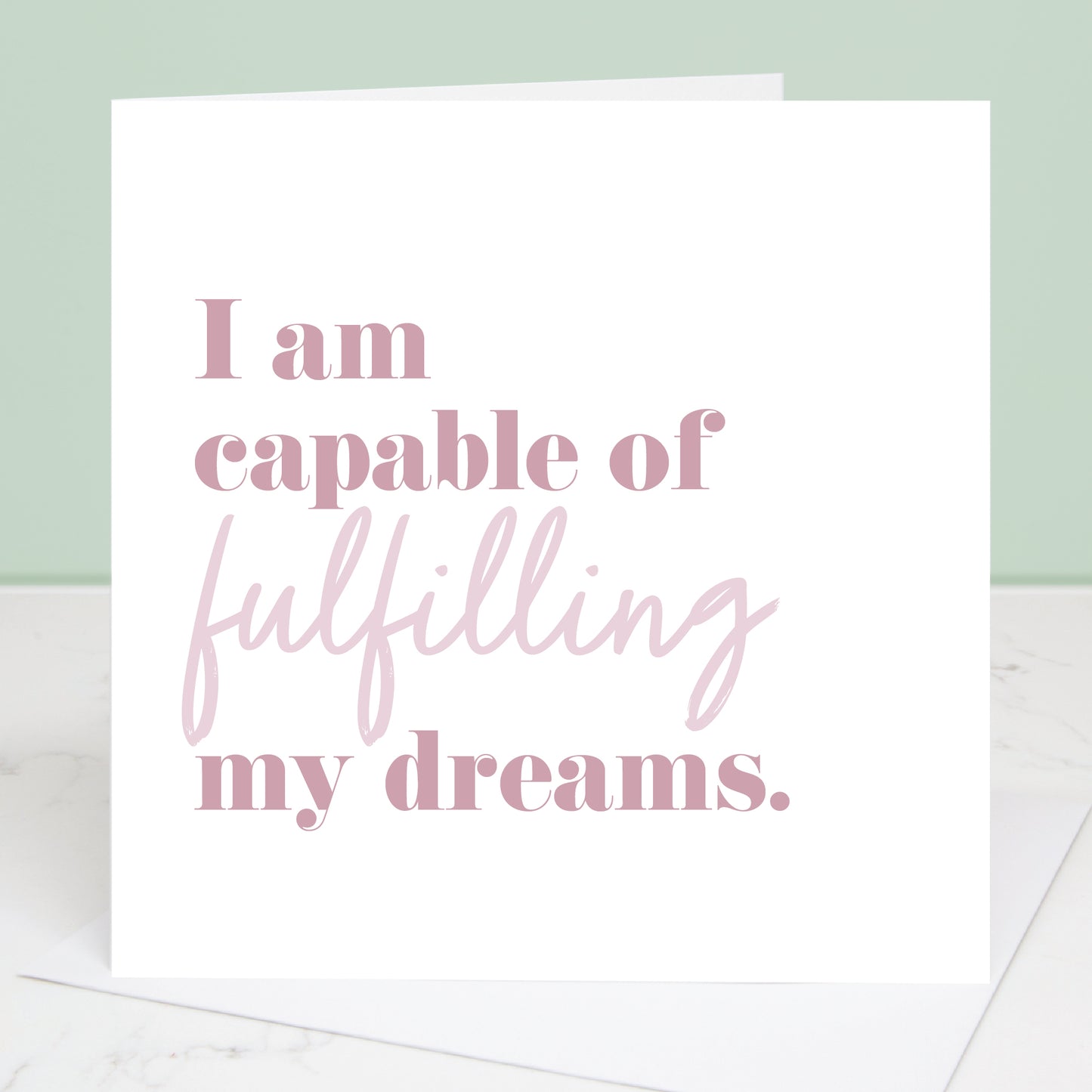 Motivational card with text 'I am capable of fulfilling my dreams' on a white background.