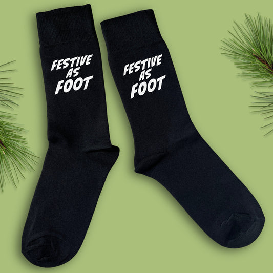 Black socks with Festive As Foot text in white 