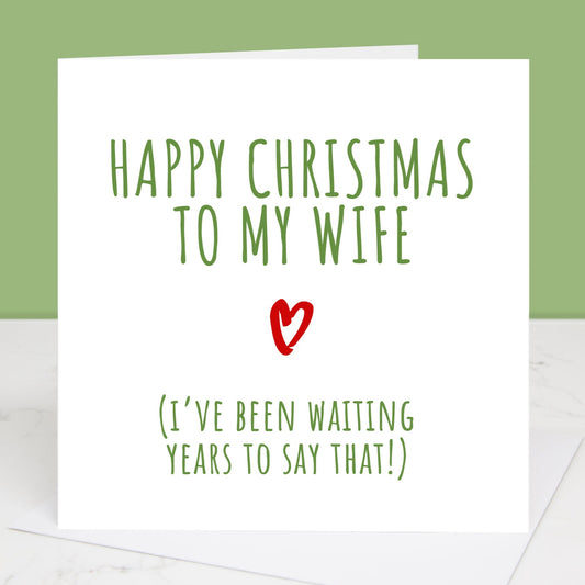 A Christmas card with a white envelope, featuring text that reads 'Happy Christmas to my Wife (I've been waiting years to say that!)' with a heart symbol.