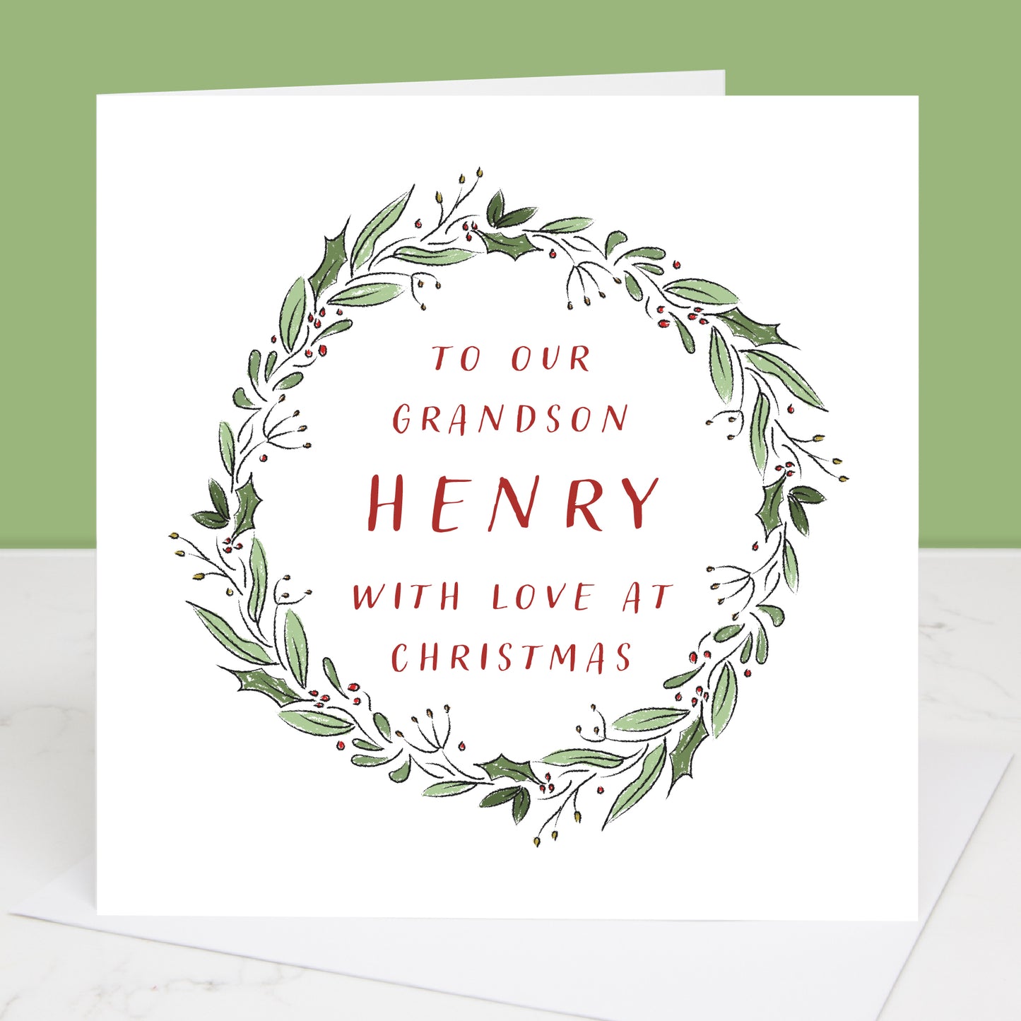 Grandson Christmas card with green leaf wreath and red text on a white background