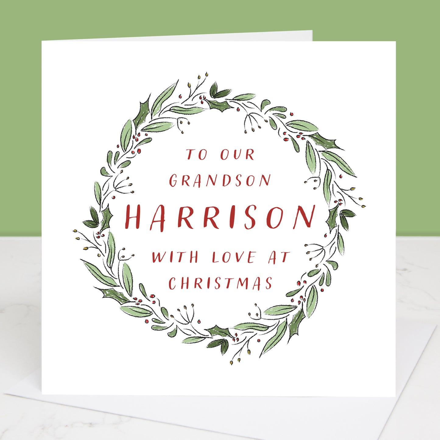 Christmas Grandson card with green leaf wreath and red text on a white background