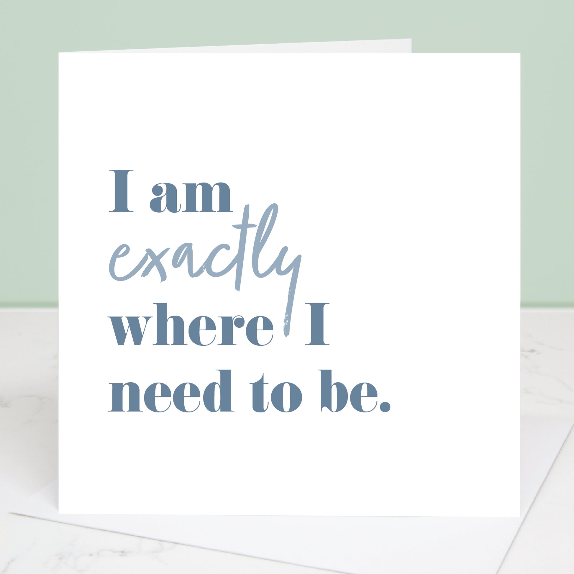 Motivational card with text 'I am exactly where I need to be' on a light green background