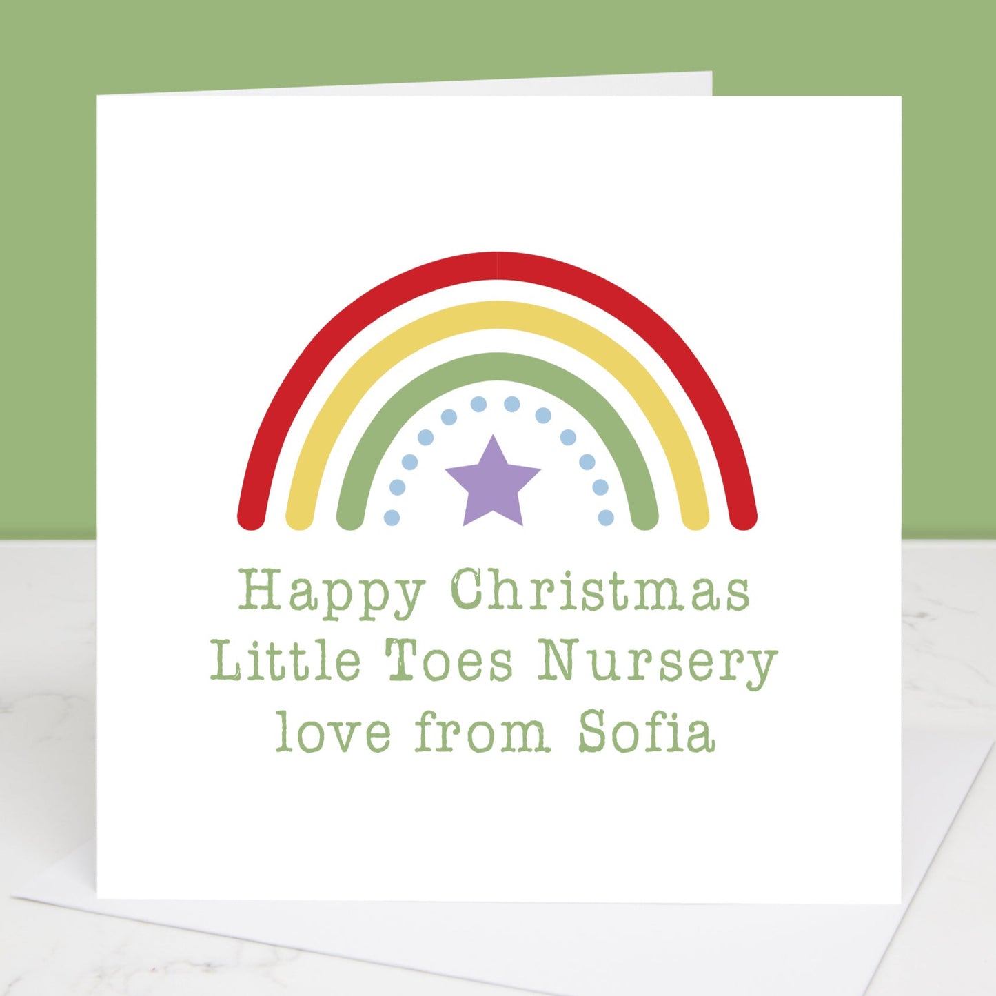 A personalised Christmas card with a rainbow design and a star, with the text the text can be personalised from the child to their nursery.