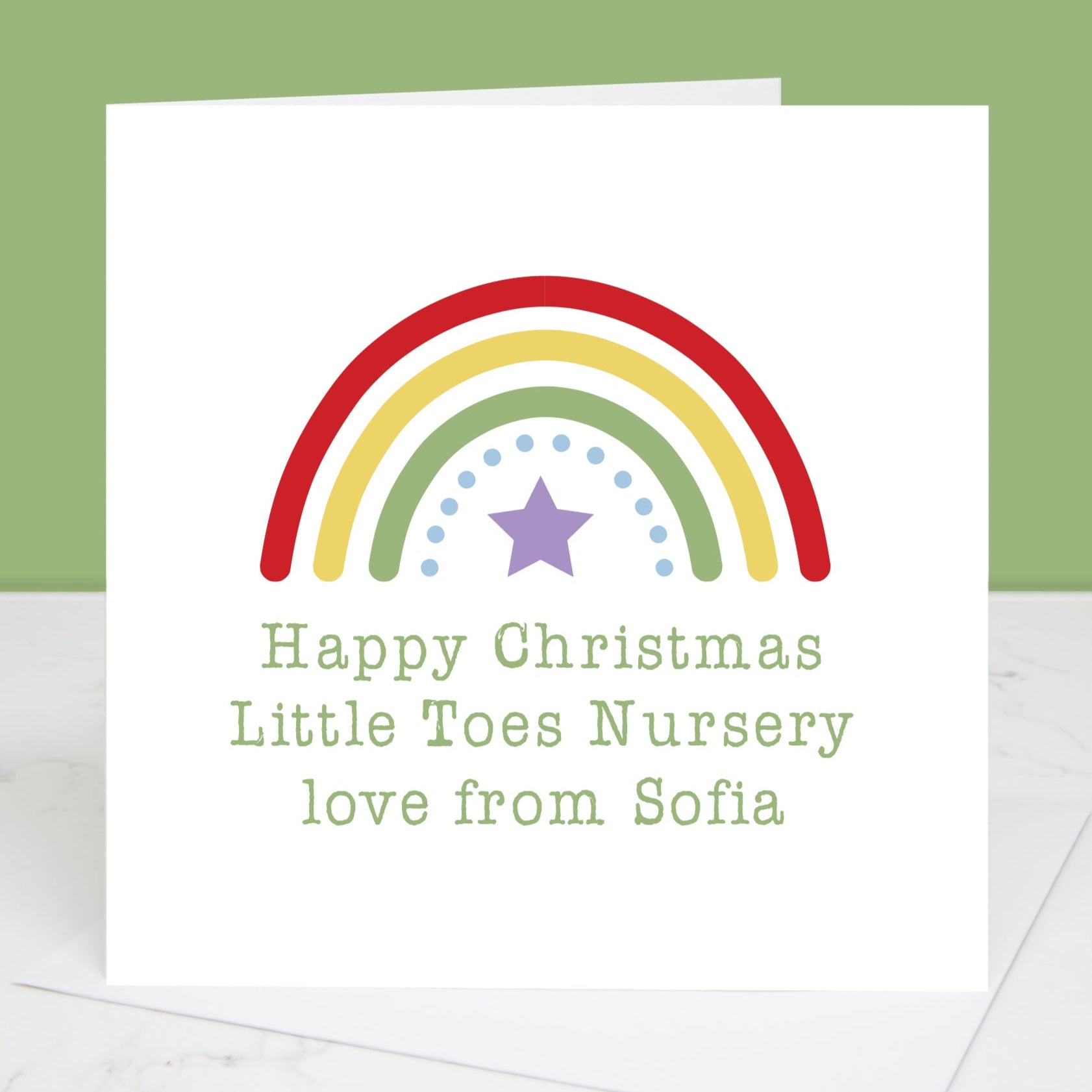 A personalised Christmas card with a rainbow design and a star, with the text the text can be personalised from the child to their nursery.