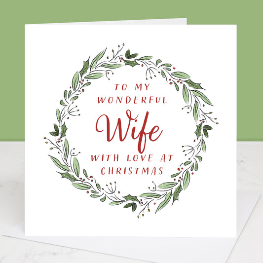 Greeting card with festive wreath design and text 'To my wonderful Wife with love at Christmas' on a white background.