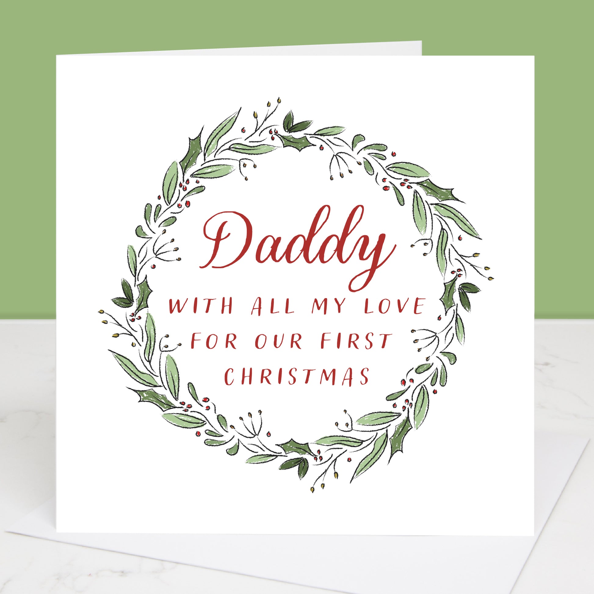 Greeting card with wreath design and text 'Daddy with all my love for our first Christmas' on a white background.