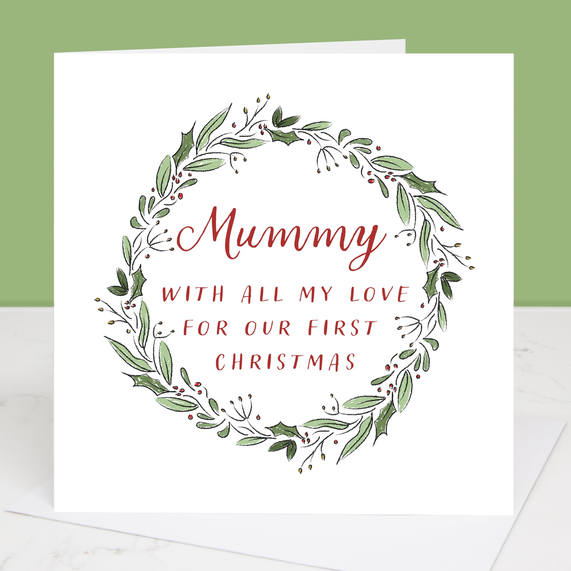 Greeting card with 'Mummy with all my love for our first Christmas' text in a decorative wreath on a white background.